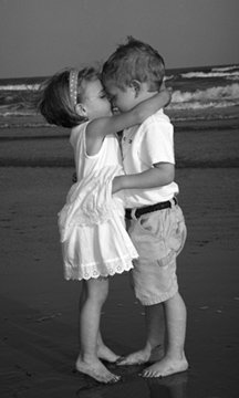 Gyerekszerelem Kislány és kisfiú csókot ad egymásnak